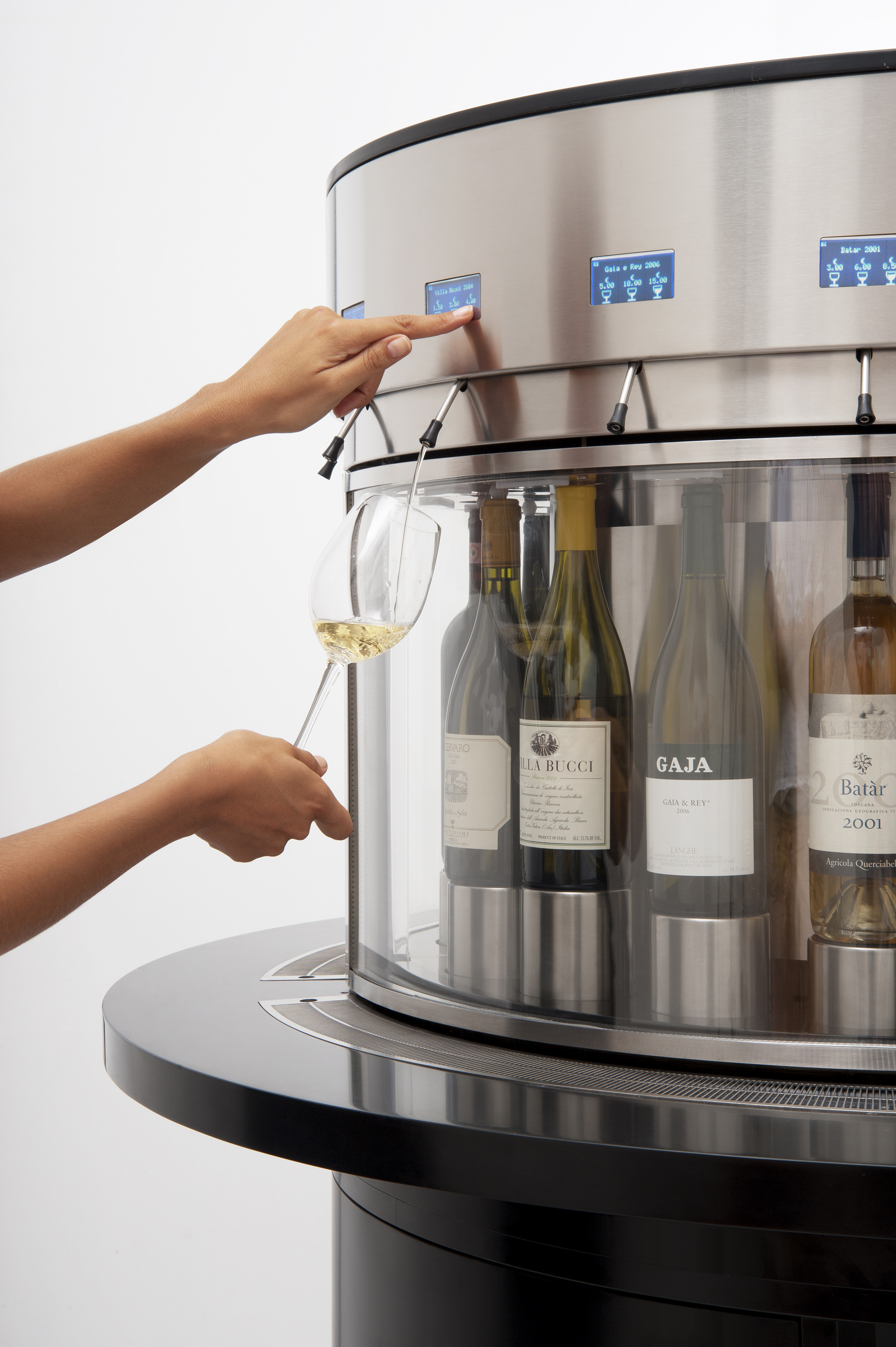 eno round enomatic wine dispenser system being used and showing wine pouring into a wineglass